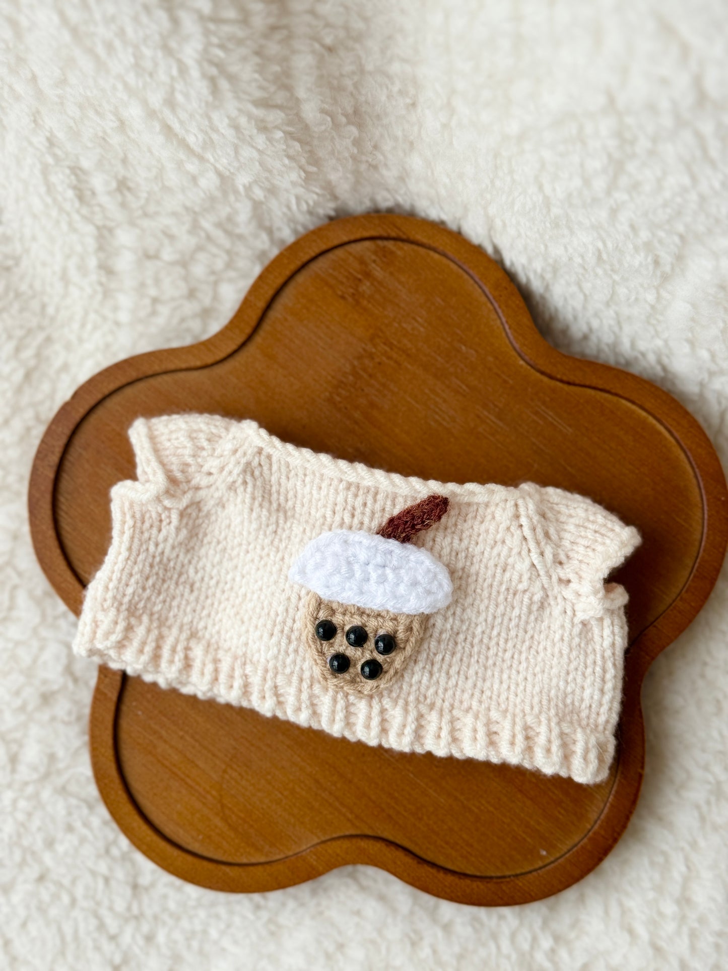 Flat lay of cream handmade knit boba tea sweater for Jellycat Bartholomew Bear Junior on wooden tray, showing full garment detail