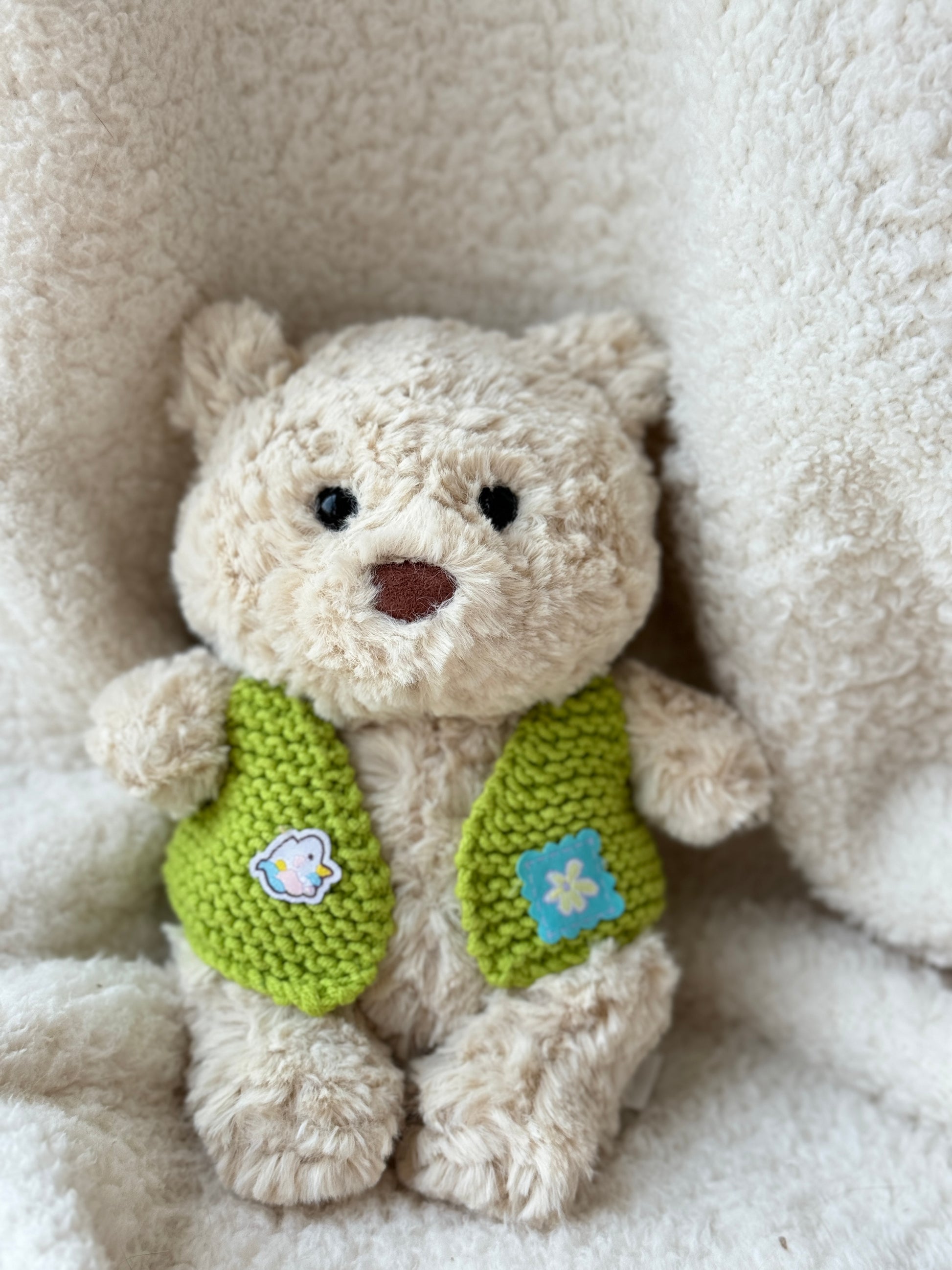 Bart Junior wearing a handmade green crochet cardigan-style vest for Jellycat collectors