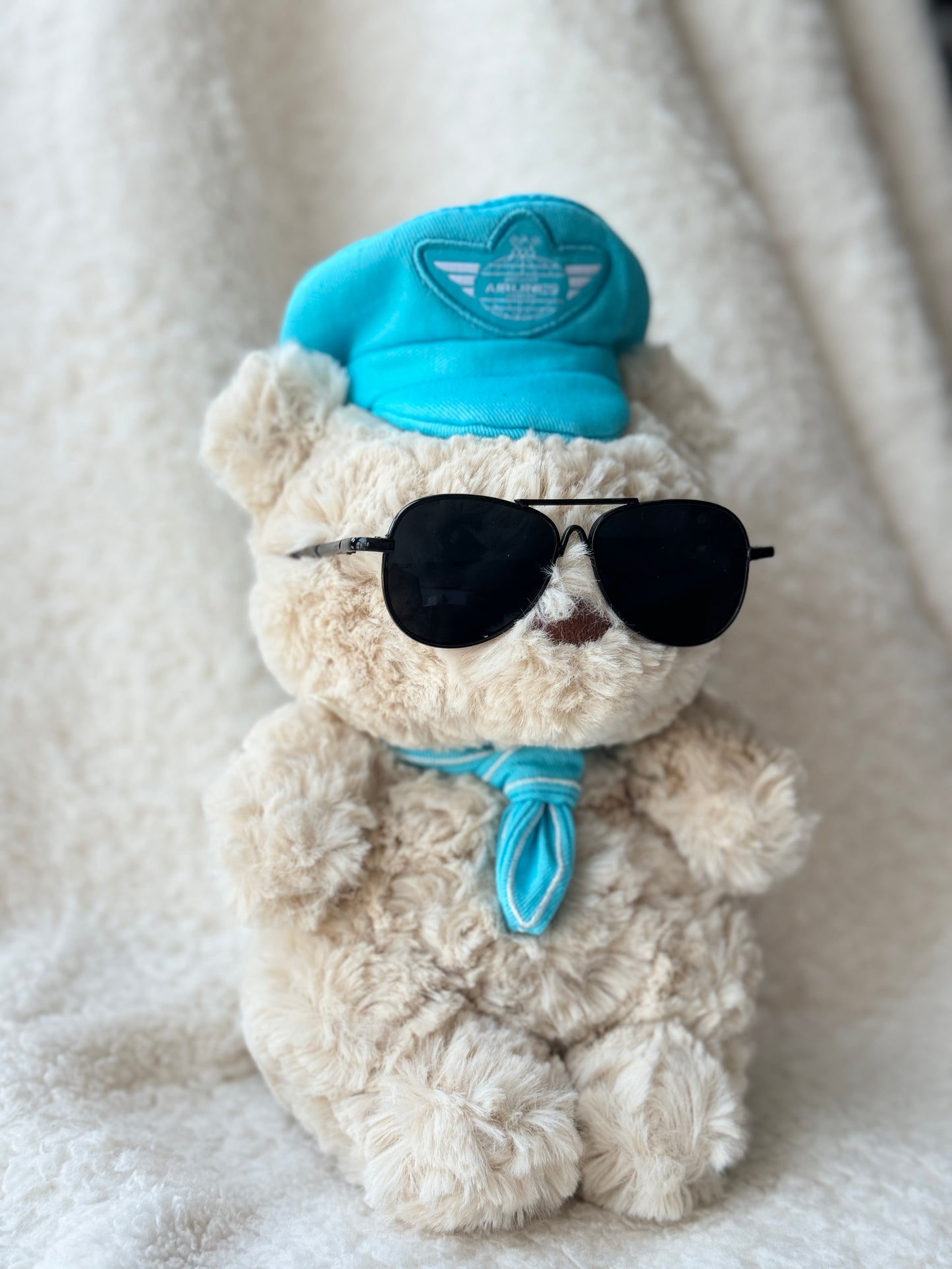 Cute pilot-style glasses for Jellycat bear plush on cream blanket