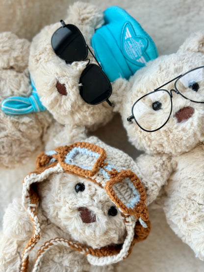 Three Jellycat Bartholomew Bear plush styled with glasses and pilot accessories
