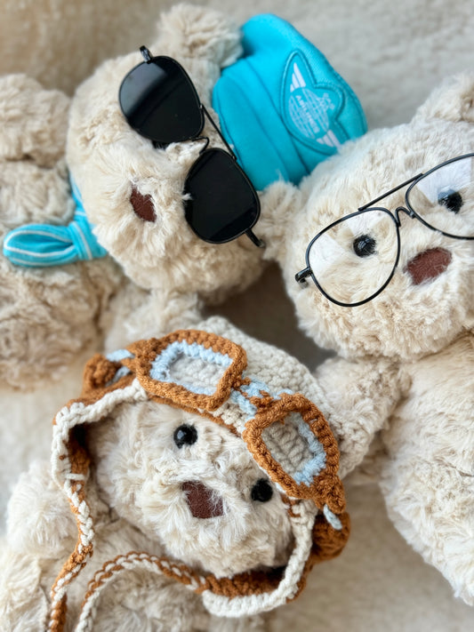 Three Jellycat Bartholomew Bear plush styled with glasses and pilot accessories