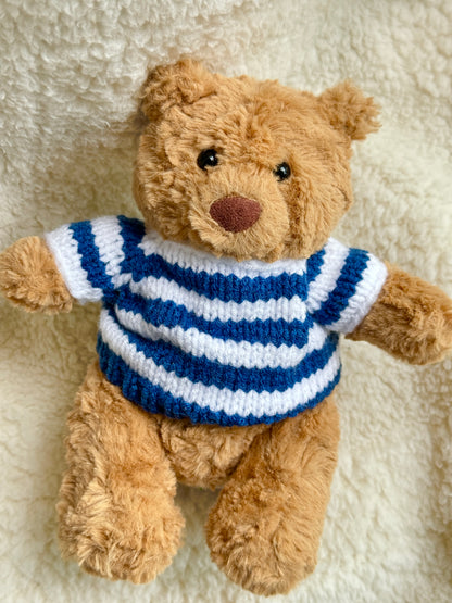 Close-up of a Jellycat teddy bear in a handmade navy blue striped knit sweater inspired by vintage maritime fashion.