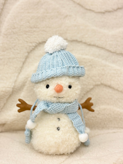 Handmade ice blue crochet hat and scarf on a snowman plush toy