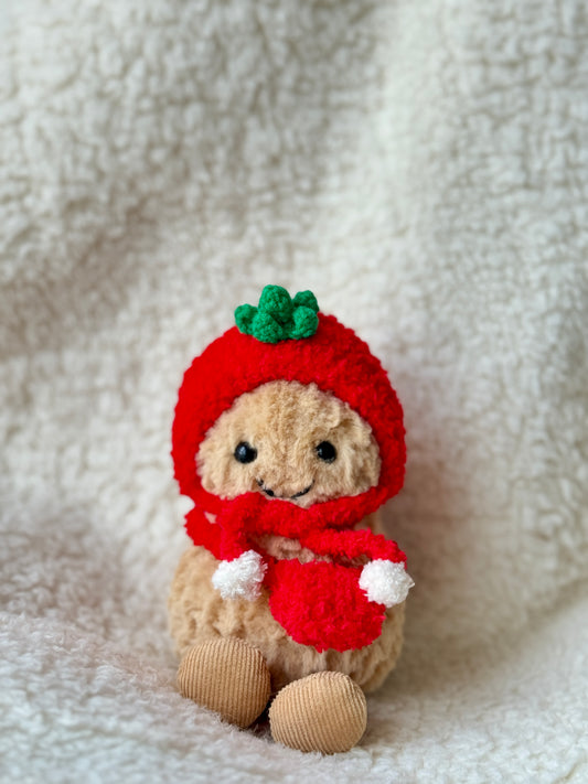 Handmade crochet tomato hat and scarf set on Jellycat Peanut, red bonnet with green leaf crown and white pompom scarf, front view